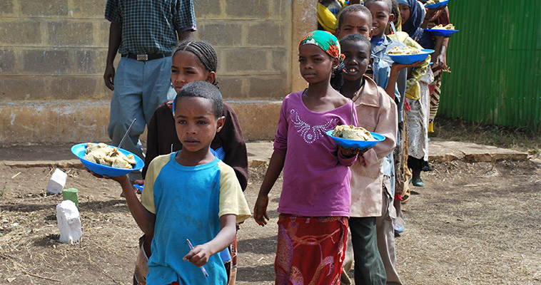 Children carry school lunches provided by the World Food Program in Ethiopia.