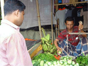 photo of a man buying produce at the market