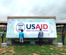Two men help open up a Ebola Grand challenge pod