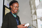 A pharmacist at an ADVANCE clinical trial site in Johannesburg, South Africa examines a bottle of life-saving antiretrovirals.