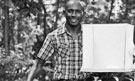 Black and white photo of Fredros Okumu smiling, showing his recognition as one of Foreign Policy's 100 Leading Global Thinkers