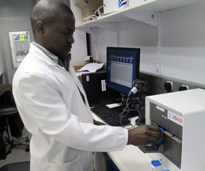 A technician in a lab coat testing samples