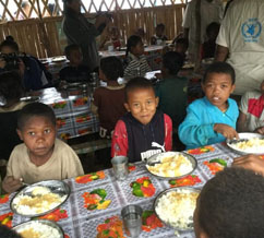 Children receive hot meals from the Sisters of Charity soup kitchen supported by Catholic Relief Services in Tshiombe. / Christopher LaFargue, USAID
