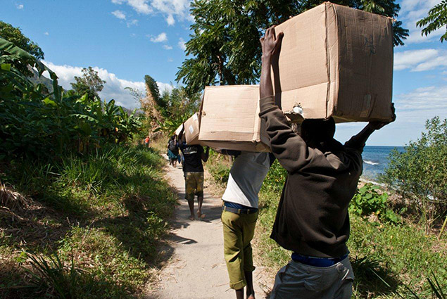 Photo of men holding boxes.
