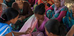 Female Community Health Worker Jharana Kumari Tharu councils a group of women, including expectant mothers.