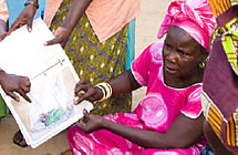 A woman looks at malaria-related learning materials
