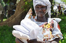 A woman holds malaria protection items 