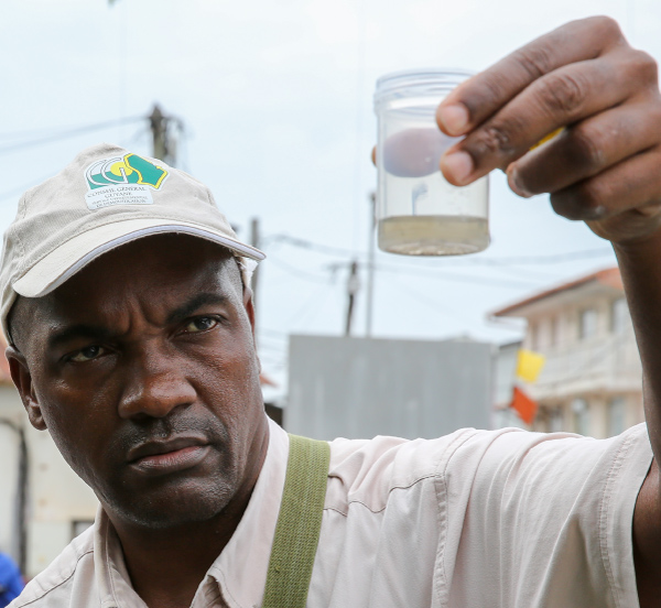 man holding sample of water