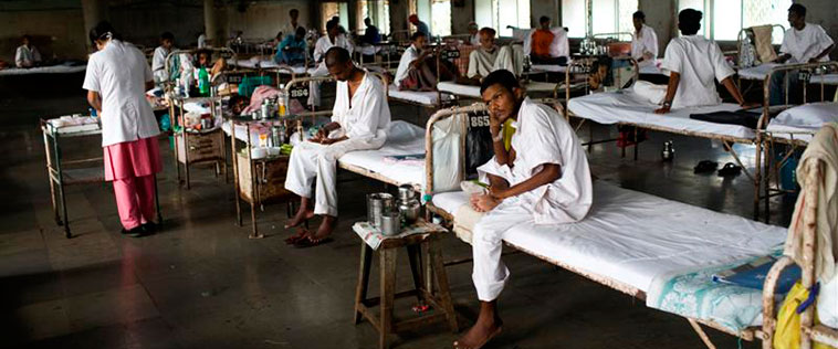Men on cots in a TB clinic.