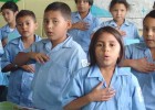 Children involved in a USAID democracy program sing the Honduras national anthem. The Agency has supported democracy programs in