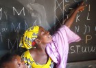 A volunteer provides literacy training to Malian youth.