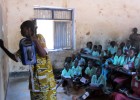 A teacher at Torit East Primary School in Torit, Eastern Equatoria state, South Sudan, holds a solar-powered, wind-up radio as s