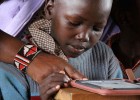An iRead student at a primary school in Ghana gets to know his new Kindle and the dozens of books that come with it.  