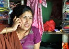 A small entrepreneur uses her mobile banking services to pay for her supplies. 