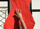 An activist sets up a red ribbon during the commemoration of the World AIDS Day in San Salvador.