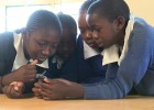 Kenyan students play a mobile game.