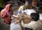 A woman receives grains in Bangladesh