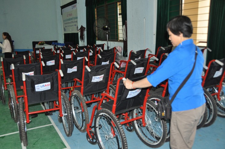 Woman organizing 30 wheelchairs for distribution in Danang, Vietnam