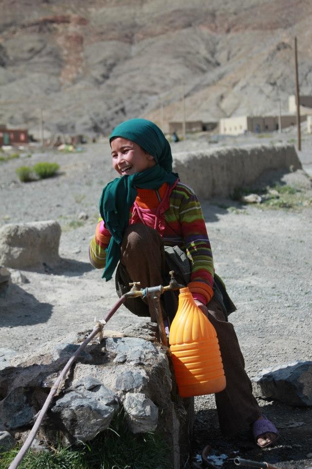 A girl retrieves water at a nearby water source in rural Morocco.