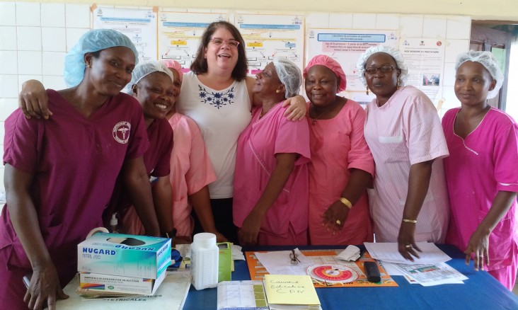 USAID Global Health Ebola Team Coordinator Bethanne Moskov, with staff at a health facility in Conakry, Guinea