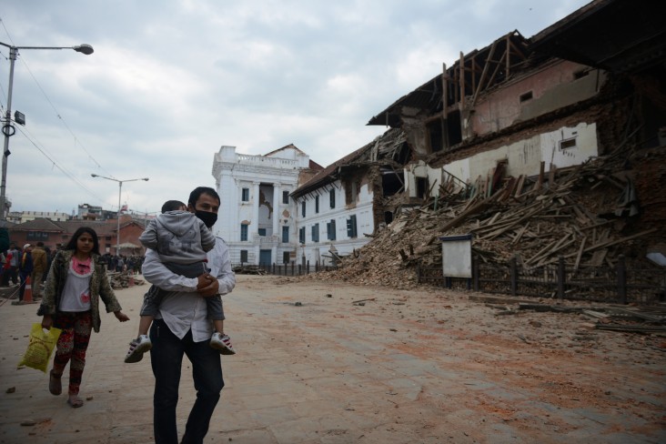 People walk past rubble in Kathmandu's Durbar Square, a UNESCO World Heritage Site that was severely damaged by an earthquake on