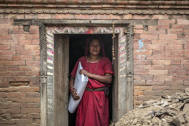 With her house too damaged to live in, she moves to her family's temporary shelter in the courtyard with plastic sheeting. 
