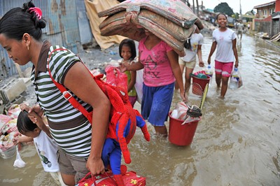 Residents escape flooding in Manila, Philippines.