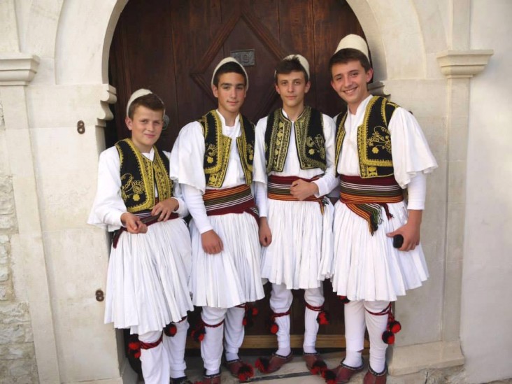 Young boys in the traditional folk costumes of Gjirokaster, a UNESCO World Heritage site, pose in this behind-the-scenes shot fr