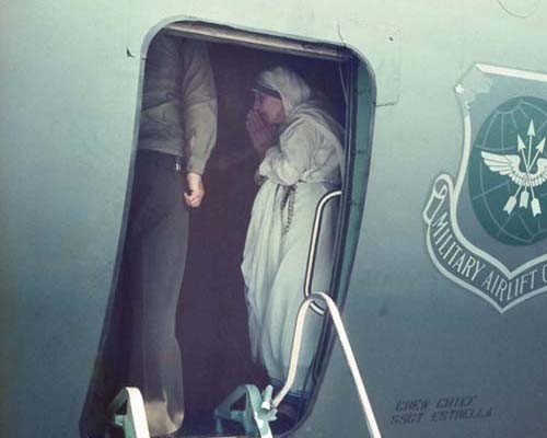 Mother Teresa on a U.S. military plane blessing the first shipment of food aid to Albania.