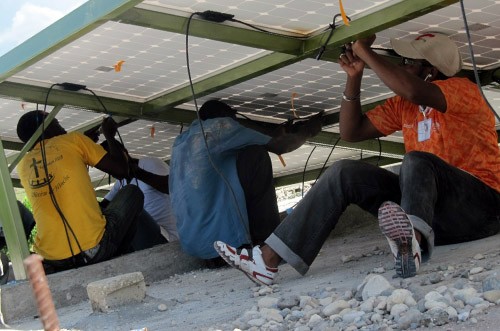 Technicians wire up solar panels as part of a hands-on training in Boucan Carré, Haiti.