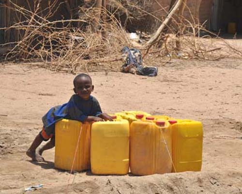An Ethiopian child at play after water is delivered to the Dire Dawa pastoralist camp.