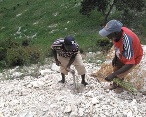Members of the Fond Baptiste community carry out labor-intensive road maintenance.  