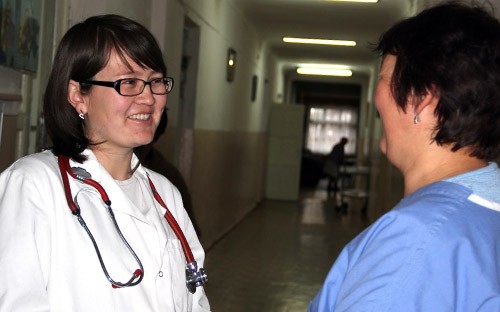 Dr. Cholpon Sadyrbaeva chats with a co-worker at their clinic in Bishkek, Kyrgyzstan.