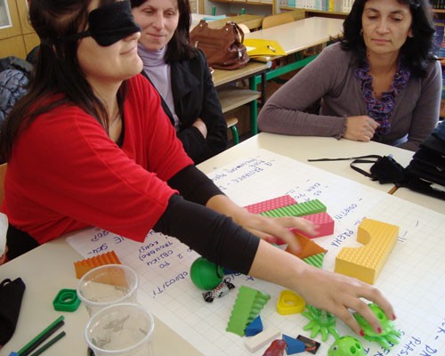 Blindfolded teachers participate in a training exercise.