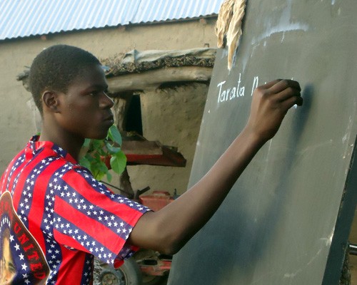 A young Malian practices basic literacy skills.