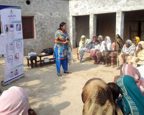 Women from Pakistan’s Khanewal district participate in a meeting conducted by a FALAH-trained health worker on healthy timing an