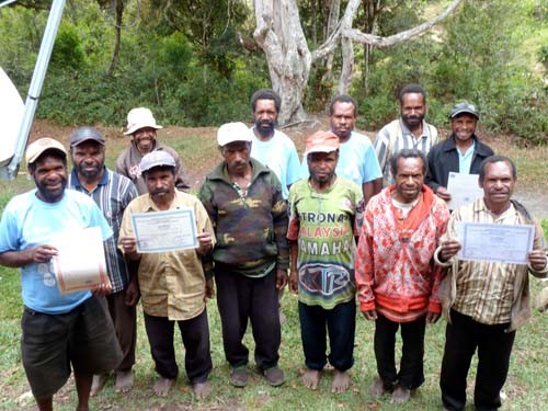 Volunteer teachers from Yahukimo District, Papua, proudly hold up their non-formal teaching certificates. 