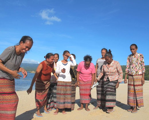 A women’s group in Com supports turtle conservation activities. Robela da Cruz is pictured on far left.