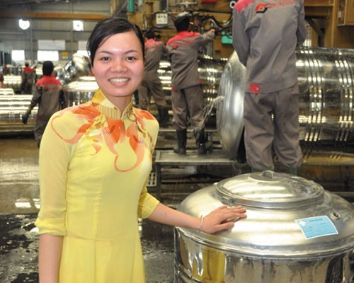 Dang Thi Phuong shows new water tanks at the Sonha factory in Hanoi.   