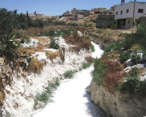 A slurry-filled Hebron waterway, prior to USAID’s intervention. 