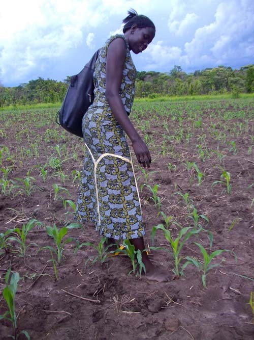 Esther Dima Kidden, an agriculture extension officer in Yei County, South Sudan, uses her foot to measure correct spacing betwee