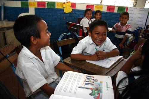 Kids in the EXCELENCIA schools are encouraged to work together. The smiling boy, center, was asked what he wanted to be when he 