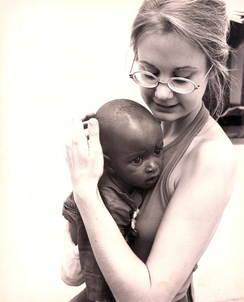 In the mid-1970's, Joan Wadelton, a Peace Corps volunteer from Princeton, N.J., holds a child at a maternal and child center.