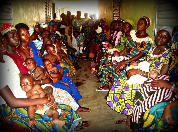 New mothers attend a baby weighing and general health wellness day at a local health clinic in Benin. 