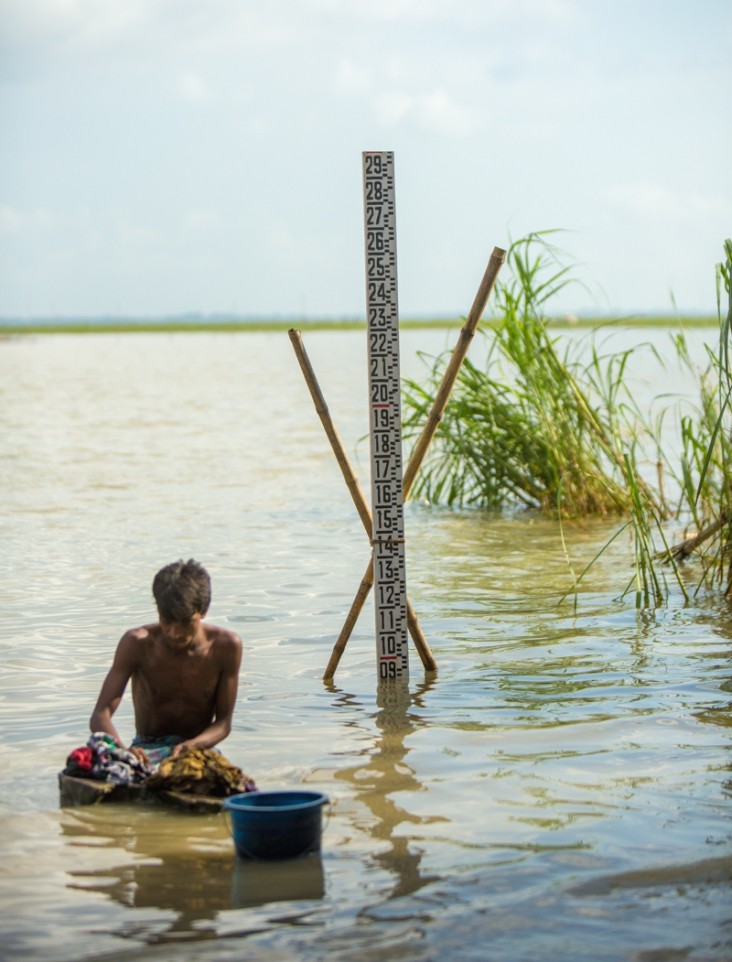 Local villagers wash their clothes near the Flood Forecasting and Warning Center’s measuring tool on the Padma River.