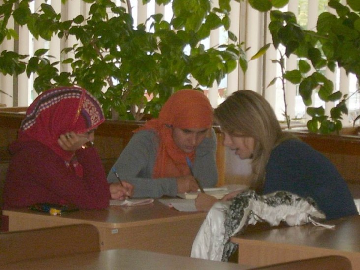 Librarian consults two recent immigrants to Ukraine. 