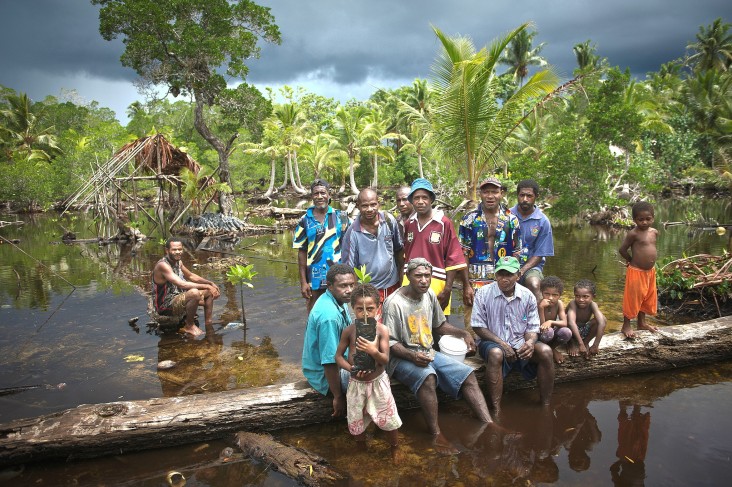 Community members of Lopahan show off shoots from their mangrove nursery.