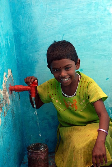 Child at water faucet