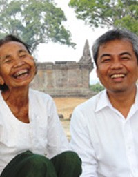 Im Chaem, left, sits beside Youk Chhang, director of the Documentation Center of Cambodia, at Preah Vihear Temple on top of the 