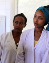 Midwife Kasech Negash, middle, and nurse Dinkineh Dawit, right, listen closely to Zergu Tafese, the USAID Integrated Family Heal